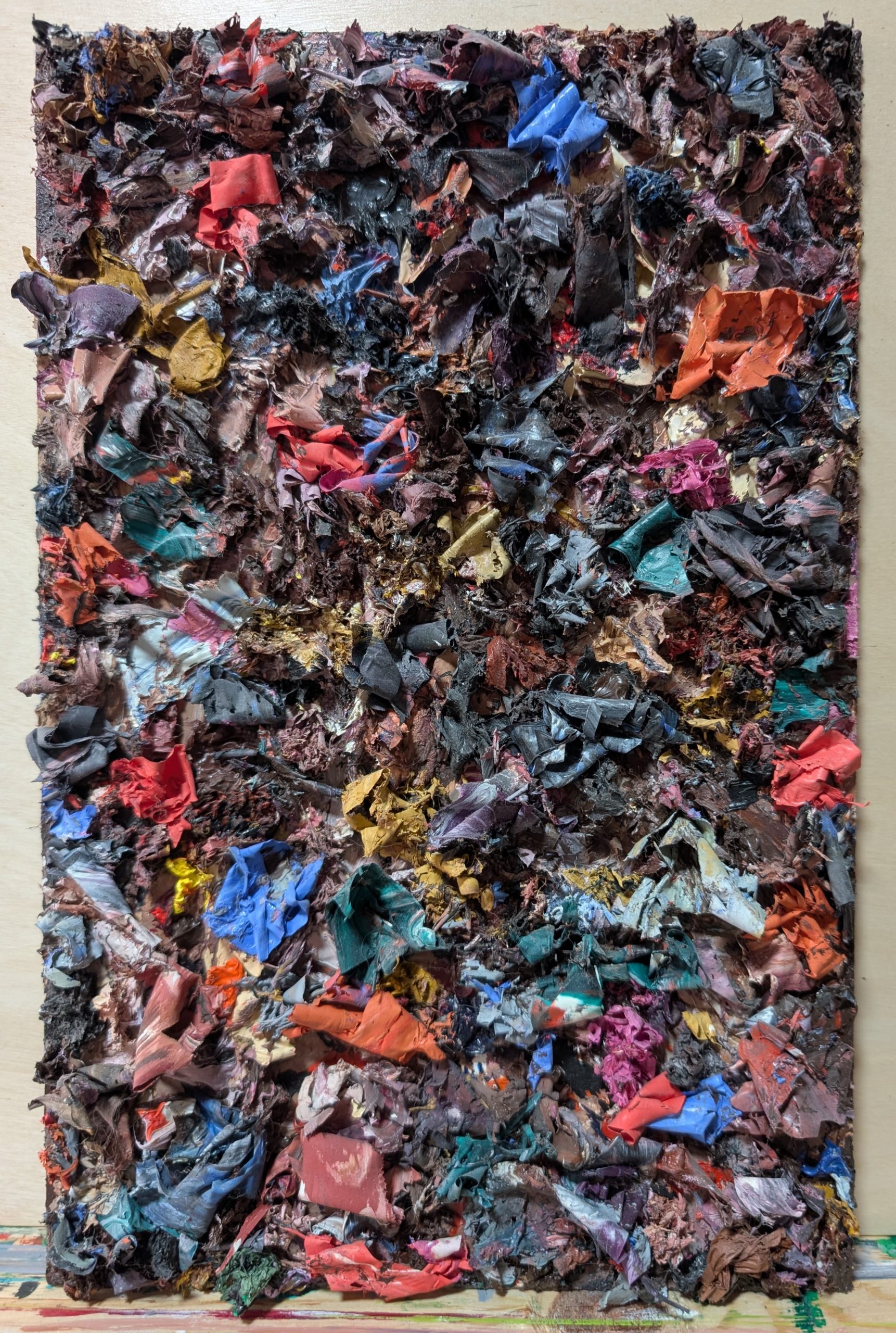 Thick ribbons and artifacts of oil paint on hardboard. Abstract.